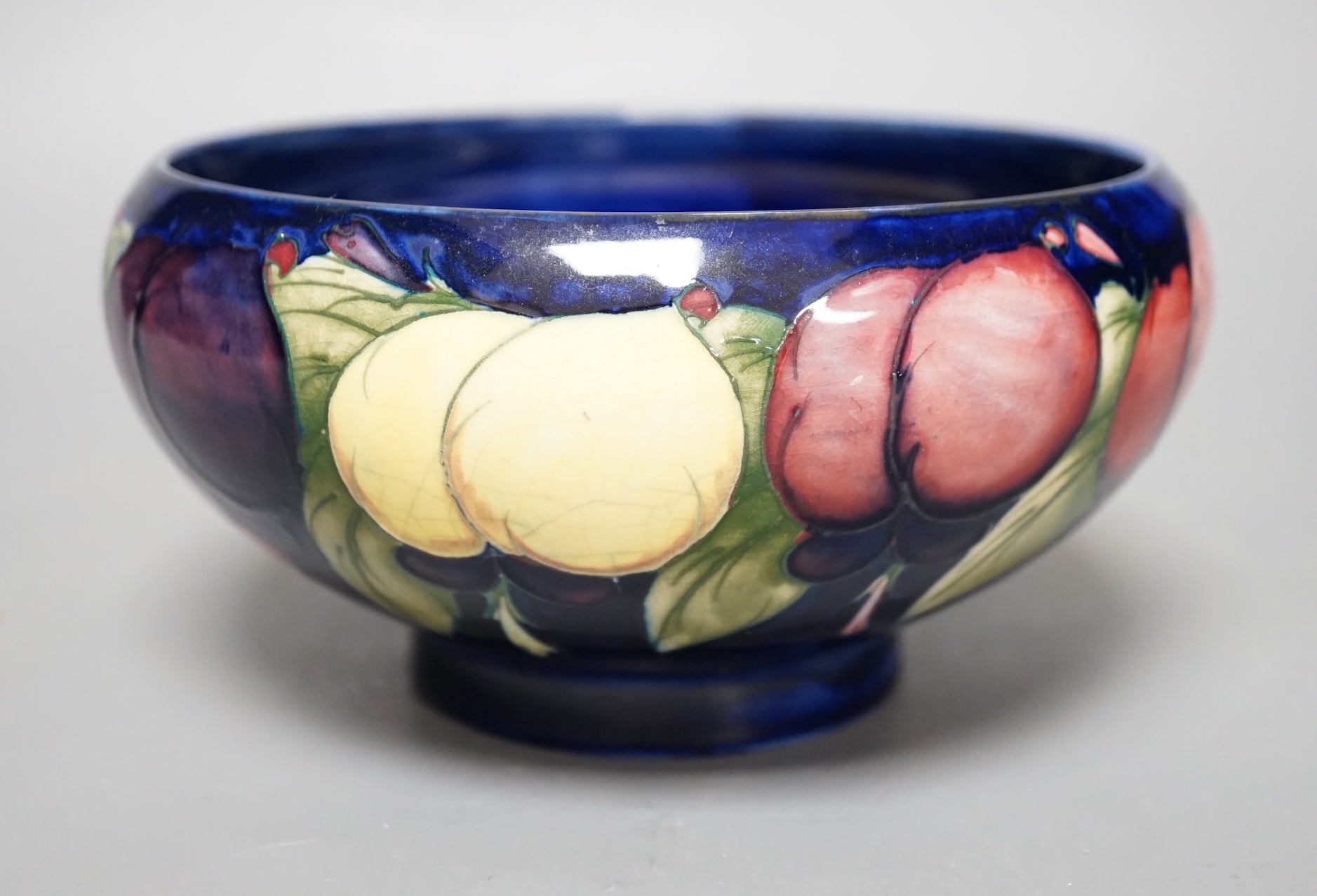 A Moorcroft Wisteria pattern bowl - 18cm wide